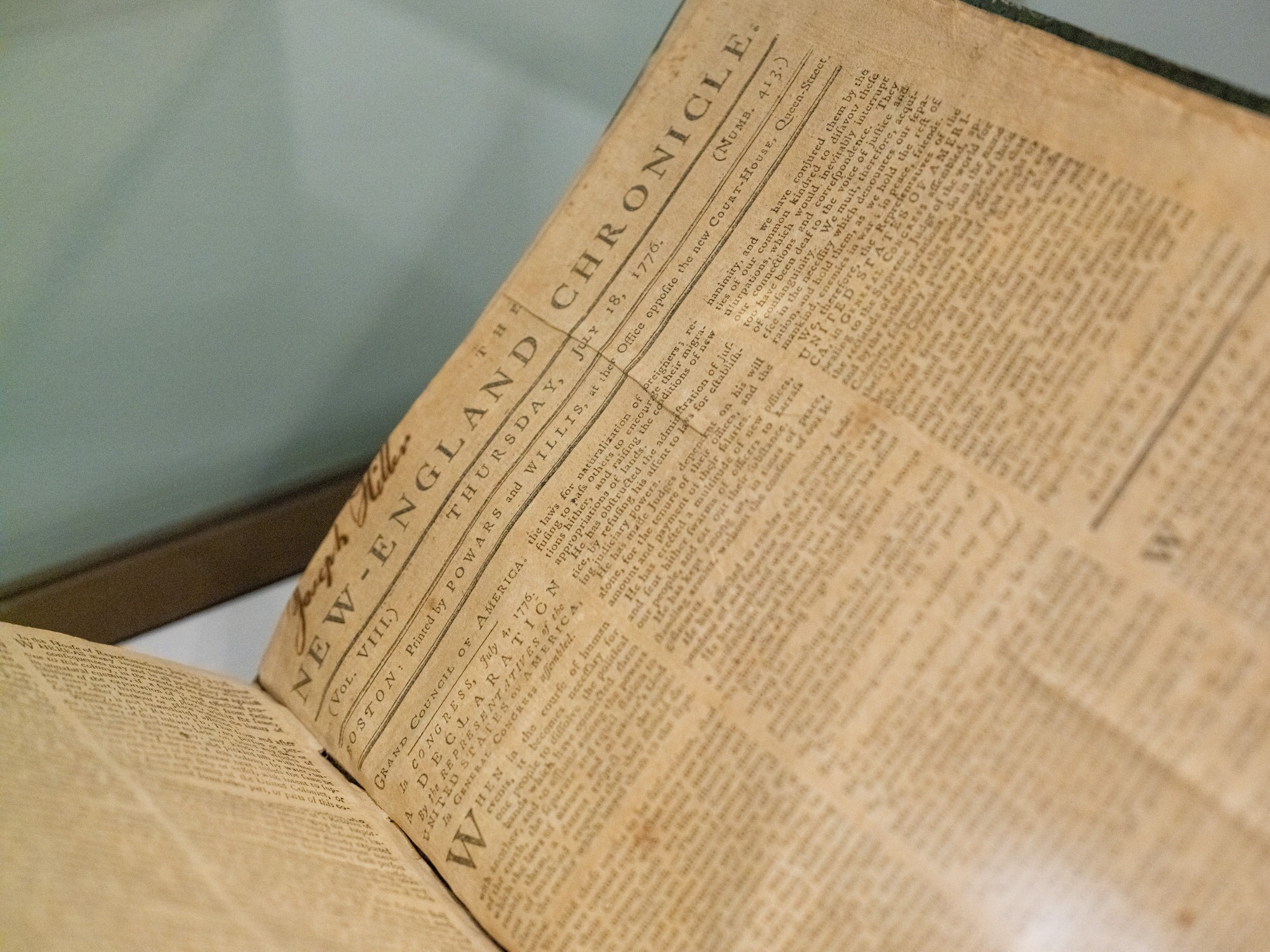 Display cases of rare books and printed material in the Imagined Nation installation at the Boston Athenæum